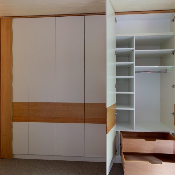 Schreinerei Freymark Freiburg, Einbauschrank vom Schreiner mit wei&szlig; lackierten Fonten und Akzenten in Kirschbaum Massivholz
